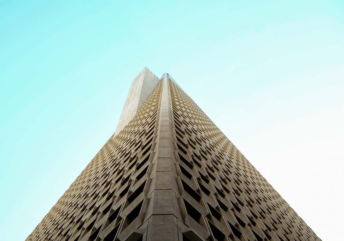corner low-angle photography of beige high-rise building tower